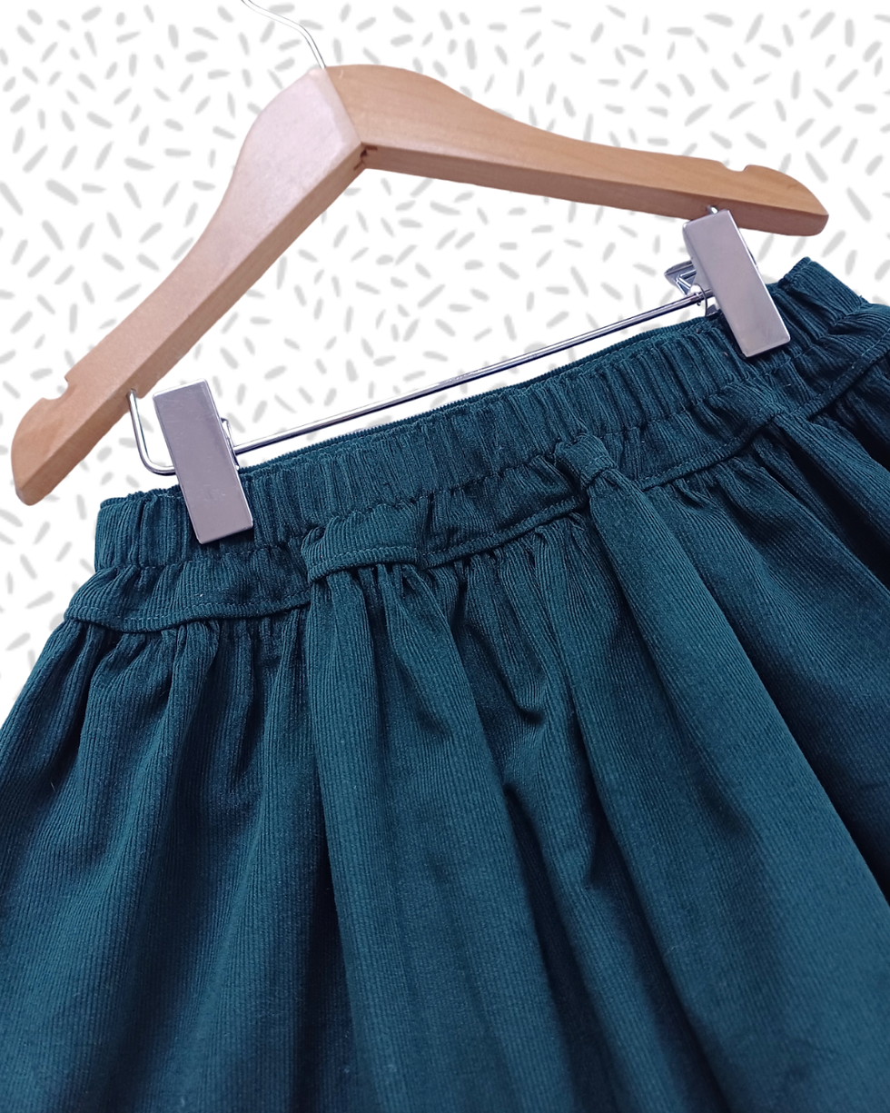 Thumbnail: The back of the handmade green elasticated skirt for girls.