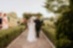 Bride walking down the aisle with her father. Wedding is taking place is a well-groomed vineyard