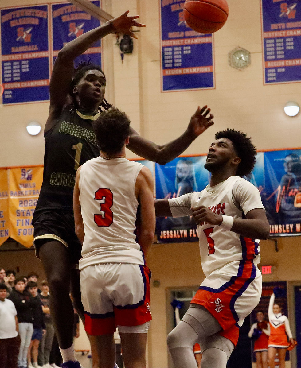 Photo by Jacob Pratt: Somerset Christian sophomore Omari Harvey (1) finds an open teammate while in the air past the defense of Southwestern senior Antajuan Dumphord (right) and junior Wyatt Stevenson (3) during the Cougars' loss to the Warriors on Tuesday night.