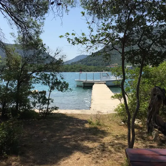 Local oyster farm boat docked and ready for an exclusive private transfer sightseeing boat tour.