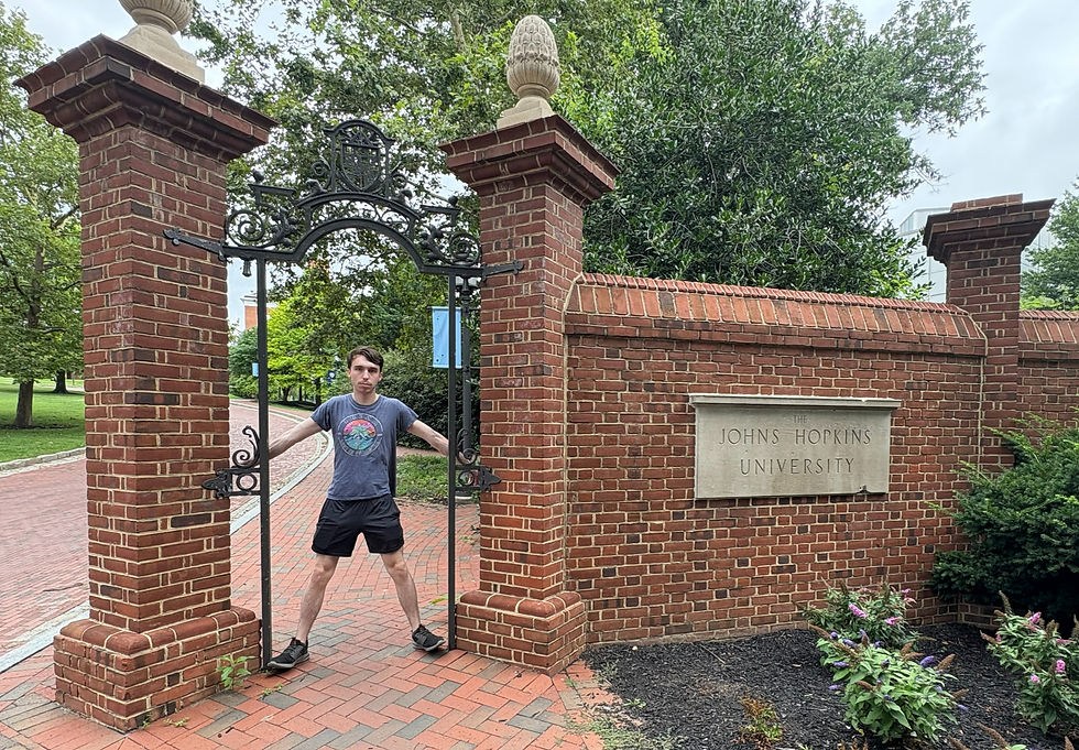 Me visiting the JHU campus on a muggy and rainy Sunday (July 13, 2025) (and indeed a very unserious picture of me sans smile, but I'm still excited to be there, of course!)