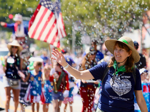 Vicki marching with Resilient Palisades in the Palisades 4th of July Parade
