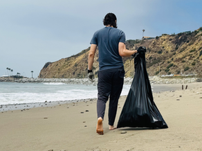 Aleksandar collects trach on the beach in Pacific Palisades