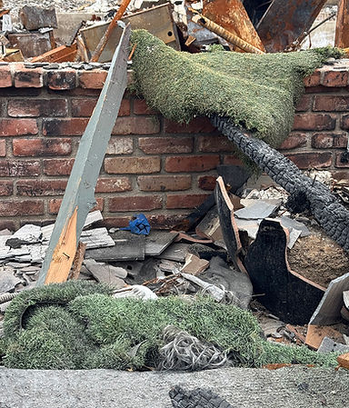 Artificial turf mixed in with debris in the aftermath of the Palisades Fire.