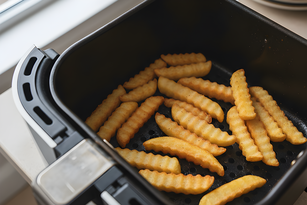 Krosse Crinkle-Cut-Pommes liegen im schwarzen Airfryer-Korb auf der perforierten Einlage.