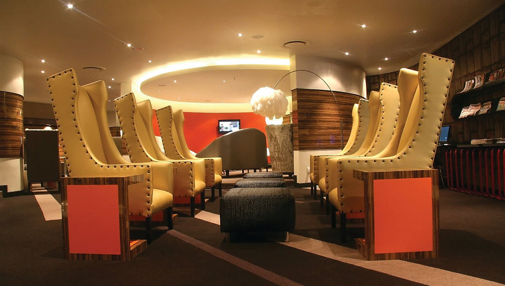 Stylish lounge space with rows of modern yellow high-backed chairs