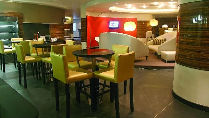 Lounge space with high-top tables and modern couches