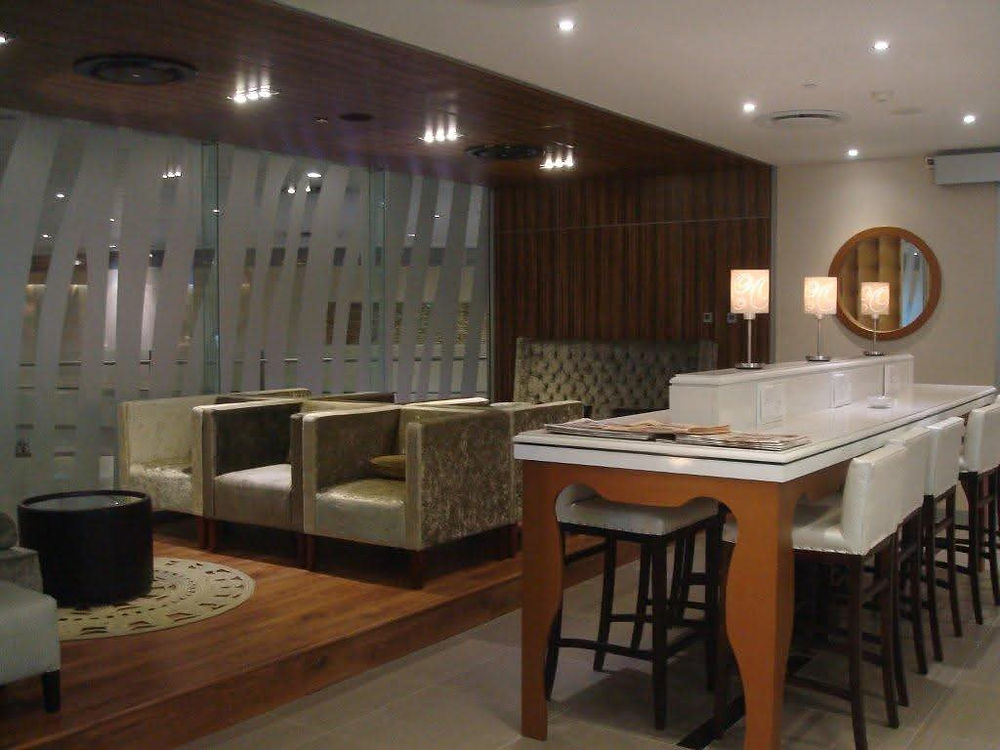 Modern lounge space with armchairs and bar seating