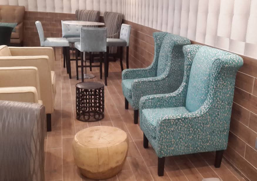 Modern lounge space with teal armchairs
