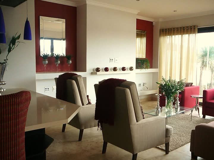 Comfortable living space with armchairs and red accents
