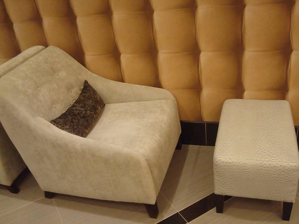 Cream armchair and ottoman in a stylish interior space