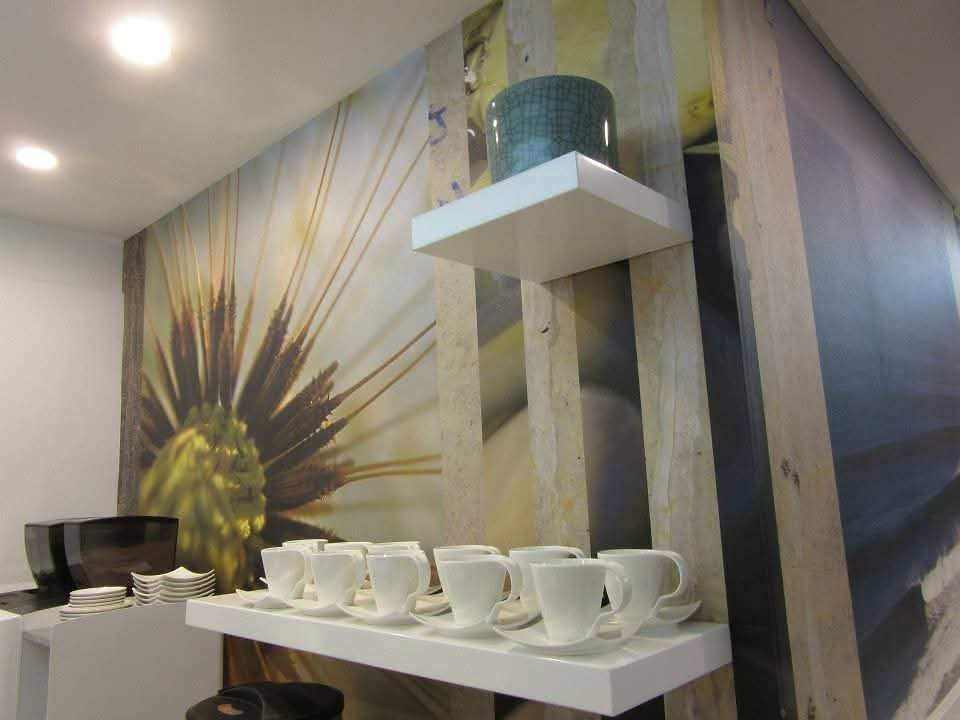 Styled beverage station space with shelves and floral wallpaper