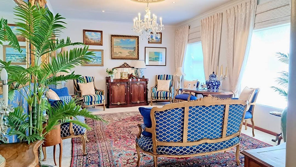 Ornate blue and gold living space with classic furniture.