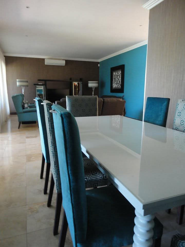 Stylish dining space with blue chairs and white table