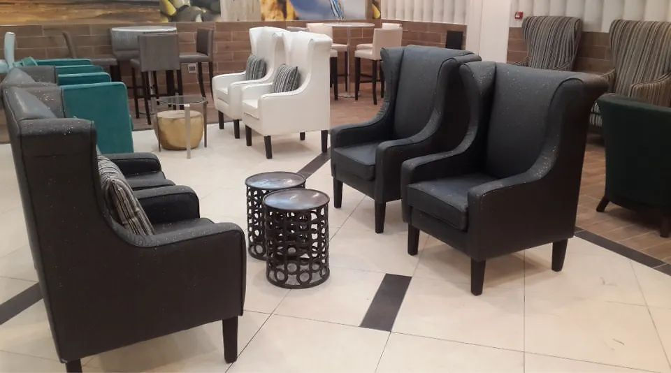 Lounge seating space with armchairs and small tables