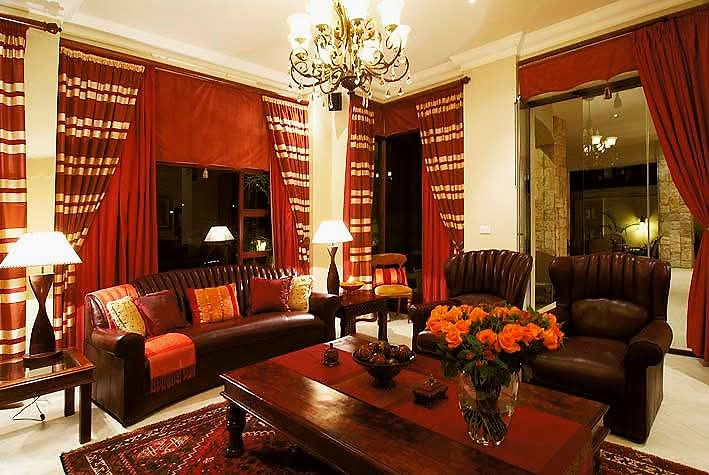 Luxurious living space with red curtains and dark leather furniture