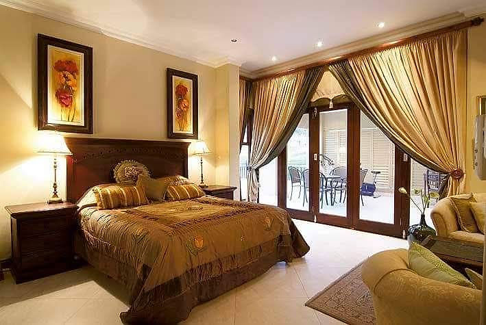 Elegant bedroom space with bed and patio doors