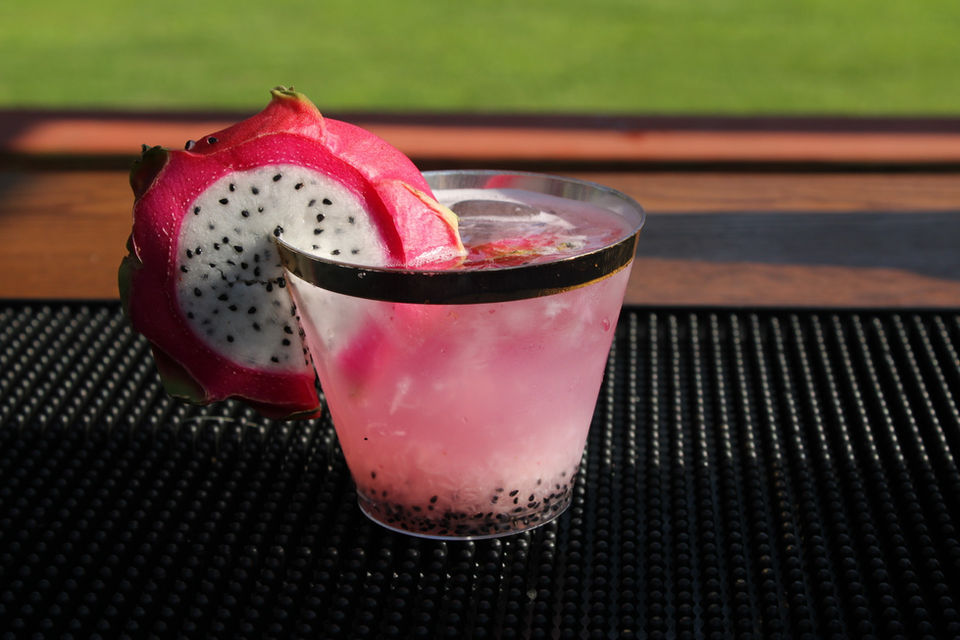 Pink dragon fruit refresher cocktail with fresh dragon fruit garnish by Sunshine Sips Mobile Bar.