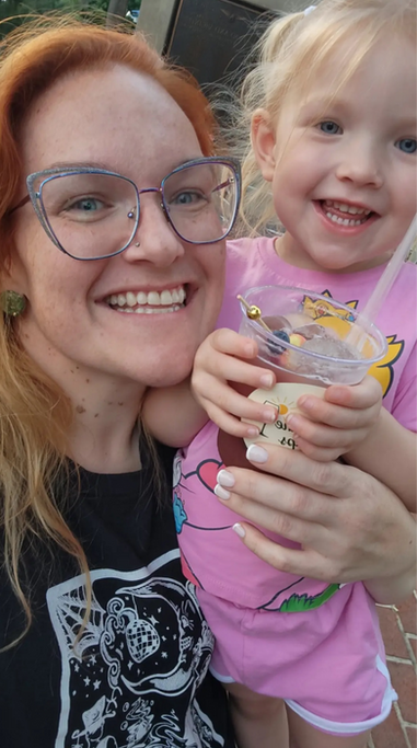 Mom and daughter smiling with a pink drink at the Sunshine Sips bar