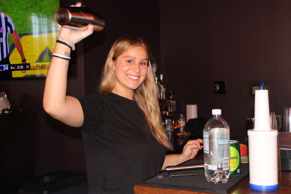 Smiling Sunshine Sips bartender shaking mocktail at  private celebration in Berlin, NJ at the Cue Box!