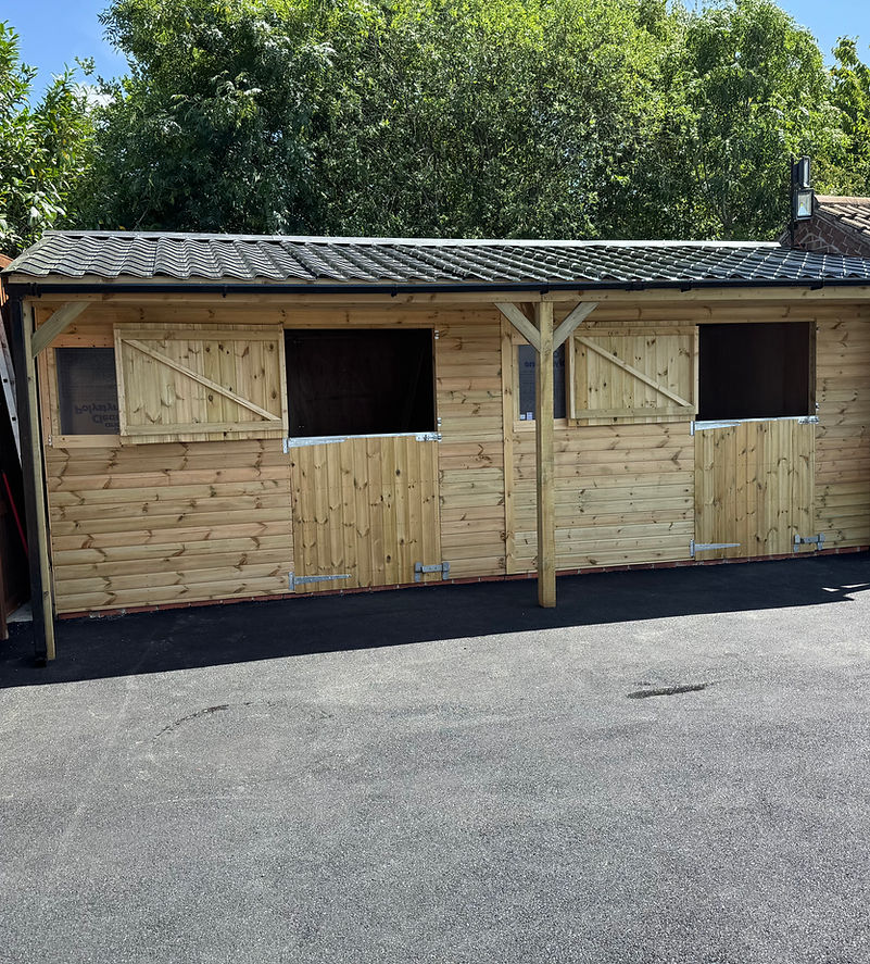 timber stable with tarmac pad