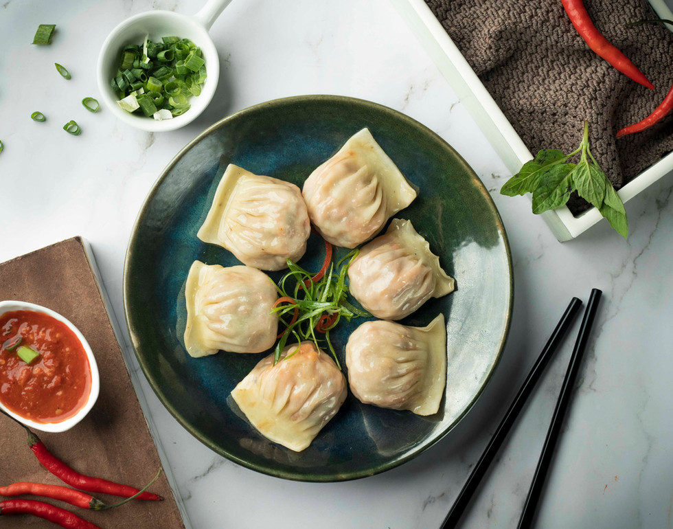 Thai style fish momo on a plate, a mouthwatering blend of Thai and momo flavors.