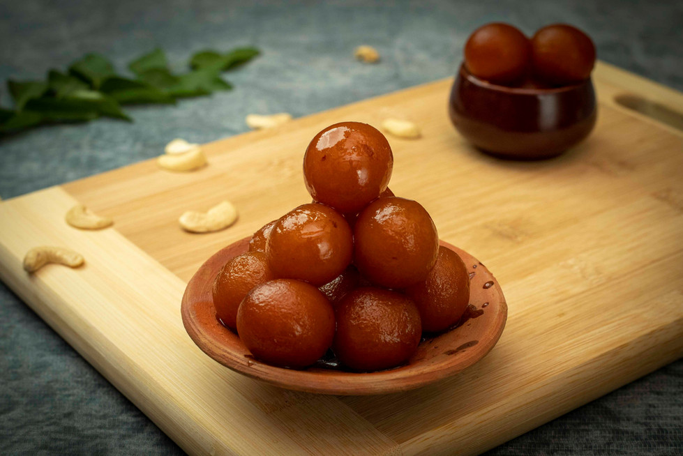 delicious gulab jamun on a clay plate
