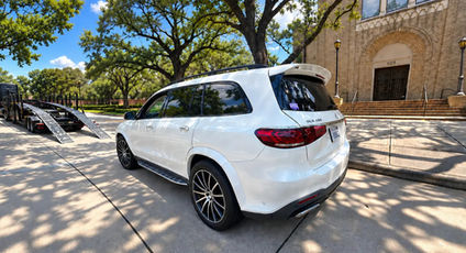 White Mercedes GLS delivered from California to Texas with an open trailer auto transport carrier.