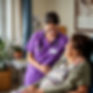 Home health nurse in purple scrubs with patient.jpg