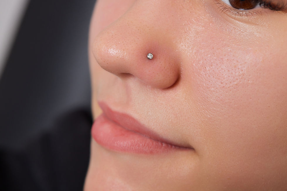 Closeup of a young woman's visage with piercing septum hanging from her nose..jpg