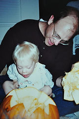 Reed and his dad carving pumpkins