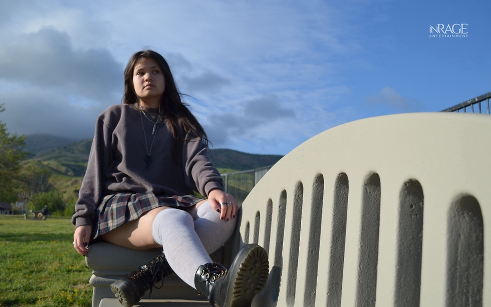 photo of Nyah sititng on a bench outside