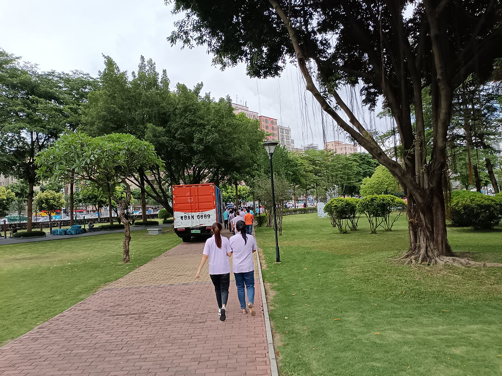 Ms. Mei (Xiao Mei), first from the left, walking across the park beside the Regina Miracle Factory with her friend after the afternoon work session ended