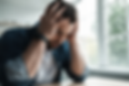 Man with head in hands struggling with anxiety