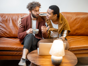 Couple sitting on couch talking intensely