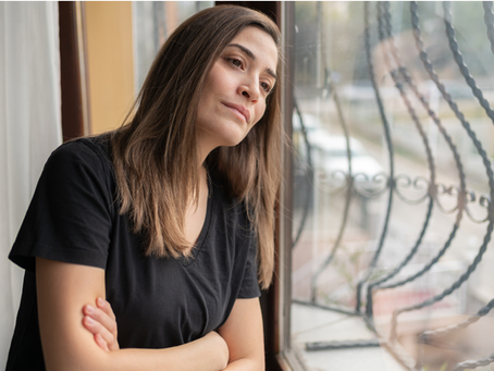 Woman staring out window considering seeing a Sydney psychologist