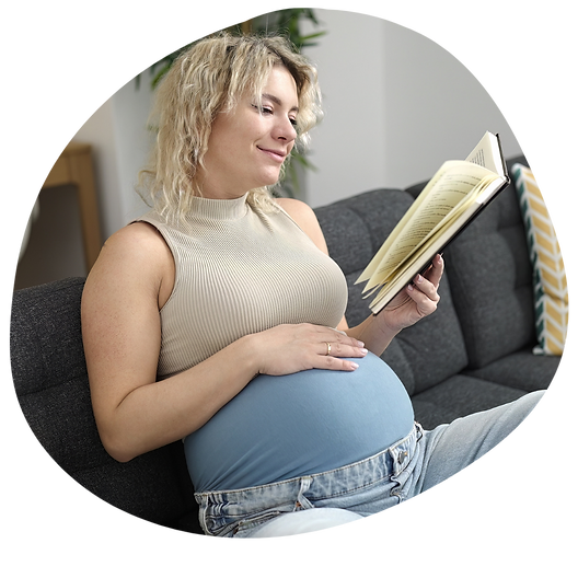 Pregnant young woman reading on couch