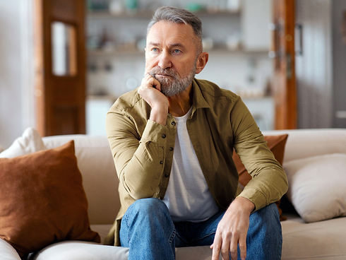 Middle aged man sitting on couch