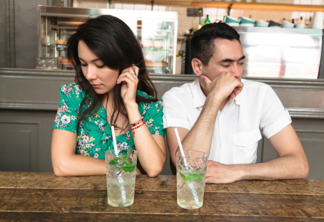 Couple sitting in a cafe fighting