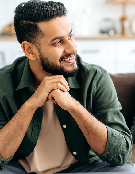 young adult indian man sitting on couch in counsellilng session