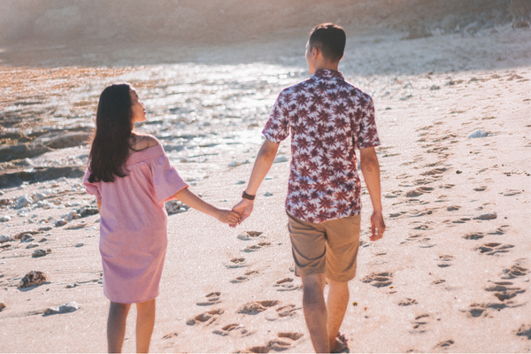 Couple walking along the beach holding hands