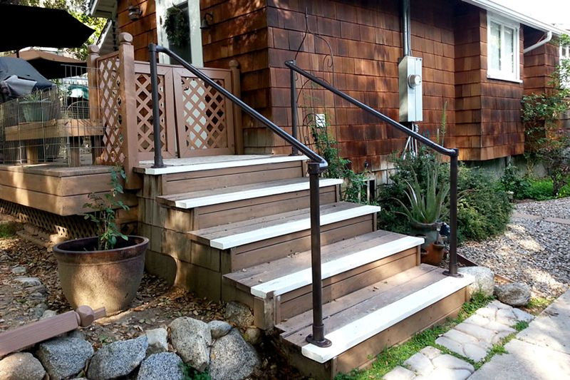 Front home entry steps with sturdy handrails installed on both sides to improve fall prevention and age-friendly home accessibility.