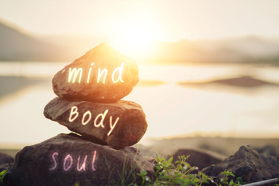 Three stones stacked on top of each other reading mind, body and soul