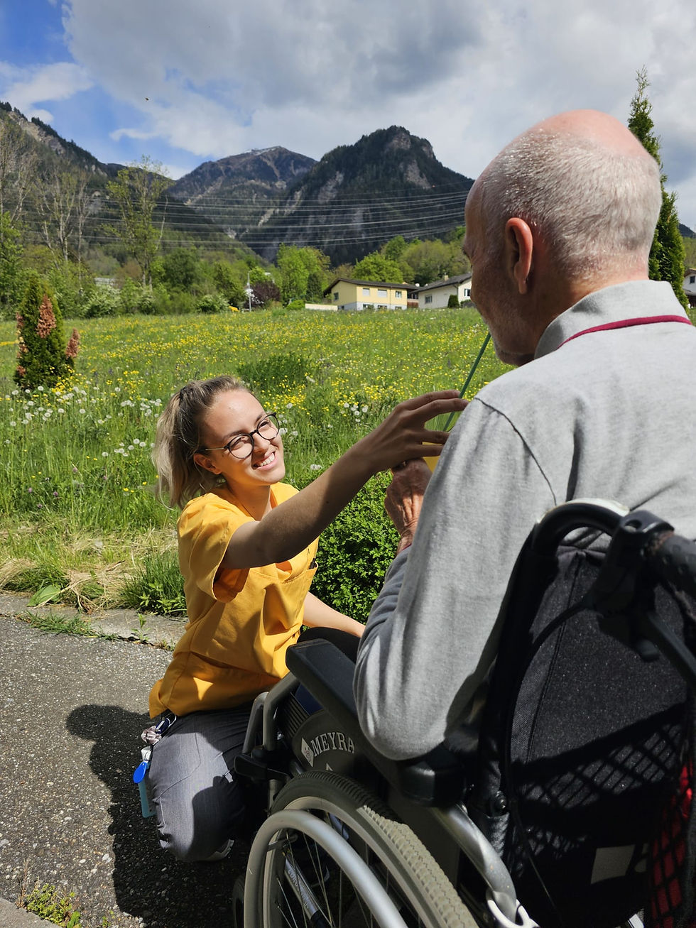 High angle view of a caring staff member assisting an elderly resident