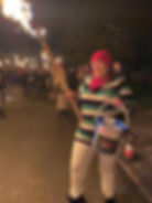 Woman in striped sweater holding a torch and charity bucket