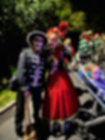 People in Day of the Dead costumes at a night event