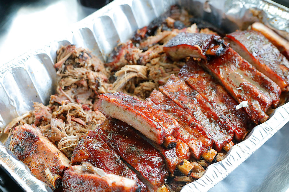 Catering tray with brisket, sausage, ribs, and sides from Butcher’s Korner in Nederland TX
