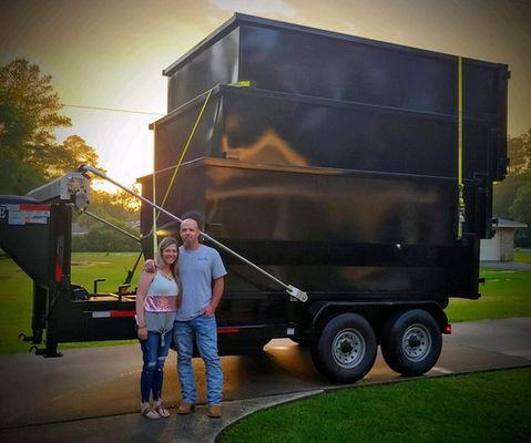 Extra Mile Enterprises owners with roll-off dumpster rental in Lumberton TX