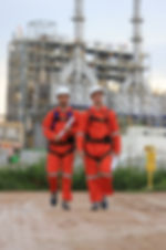 Picture of worker walking on site at a refinery