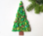a small christmas tree made from colourful tissue paper
